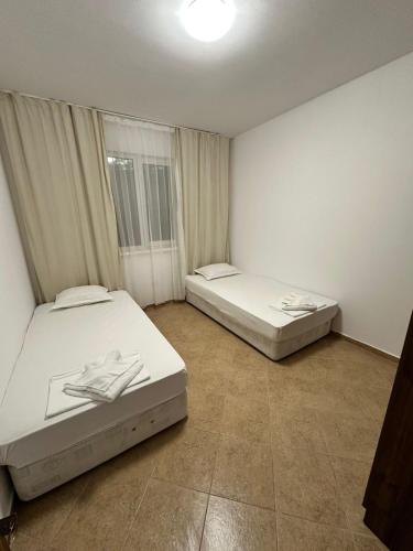 two beds sitting in a room with at Horizont Apartments in Sunny Beach