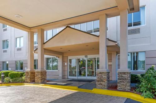 a large white building with columns and windows at Comfort Suites Raleigh Walnut Creek in Raleigh