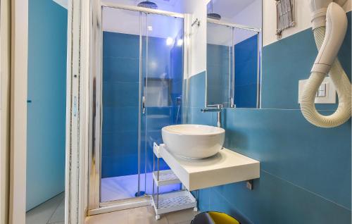 a bathroom with a sink and a glass shower at 4 Bedroom Cozy Home In Mascalucia in Mascalucia