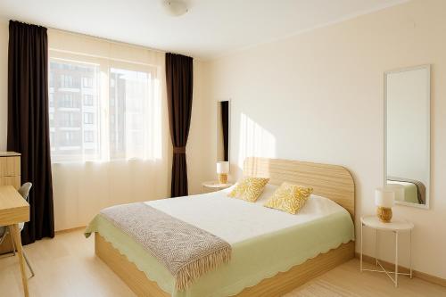 a bedroom with a bed and a large window at Apolon-7 Sea Breeze Apartment in Nesebar