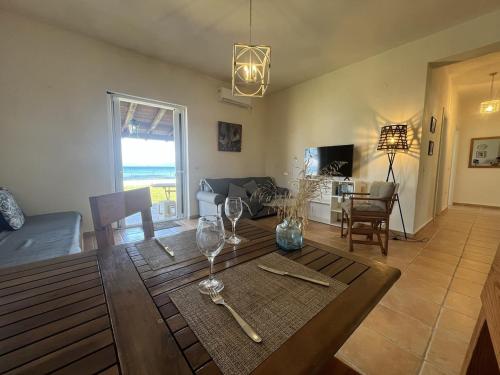 a living room with a table with wine glasses at Beachfront Villa with Garden - Valentine Corfu in Mesongi