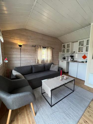 a living room with a couch and a table at Nordnes Kro og Camping in Rokland