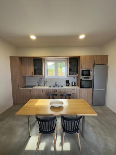a kitchen with a wooden table and two chairs at Remvi Suite in Chania in Xamoudhokhórion