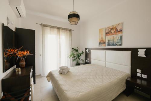 a bedroom with a bed with a teddy bear on it at Villa Apollo in Parga