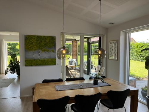 a dining room with a wooden table and chairs at Casa Jakobsen in Randers