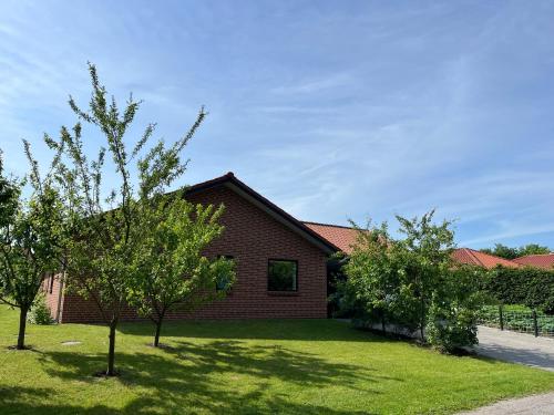 a brick house with trees in front of it at Casa Jakobsen in Randers