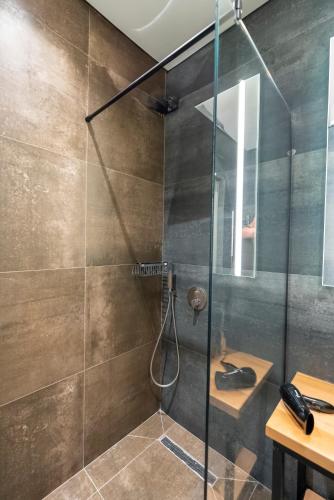 a bathroom with a shower with a glass door at Kulm Vitalonga in Radanj