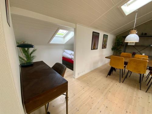 a dining room and living room with a table and chairs at Holiday home Ejby Ådal in Kirke-Hyllinge