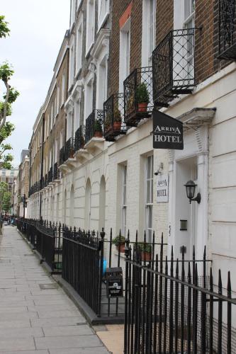 a building with a sign on the side of it at Arriva Hotel in London