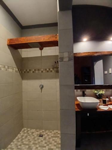 a bathroom with a sink and a shower at Mababe River Lodge in Mababe