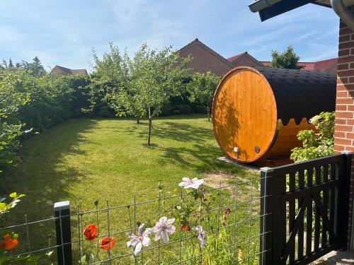 a large wooden barrel sitting in a yard at Casa Jakobsen in Randers