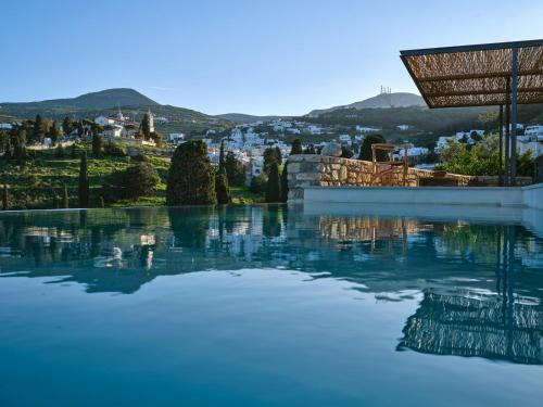a pool of water with a city in the background at Pezoules House II in Lefkes