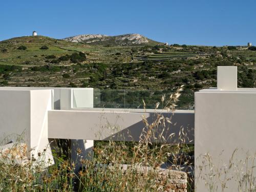 a white house with a view of a hill at Pezoules House II in Lefkes