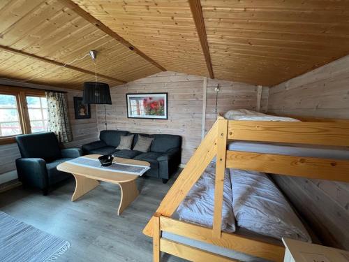 a room with a bunk bed and a couch at Nordnes Kro og Camping in Rokland