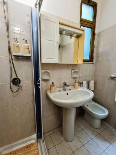 a bathroom with a sink and a toilet and a shower at Lyberty in Randazzo