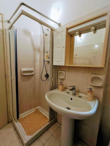 a bathroom with a sink and a shower at Lyberty in Randazzo