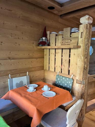 a dining room with a table in a cabin at Garni al Barance in Selva di Cadore