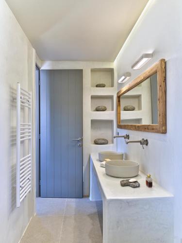 a bathroom with a sink and a mirror at Pezoules House II in Lefkes