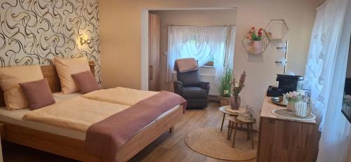 a bedroom with a bed and a chair in it at Alt Wehlheiden in Kassel