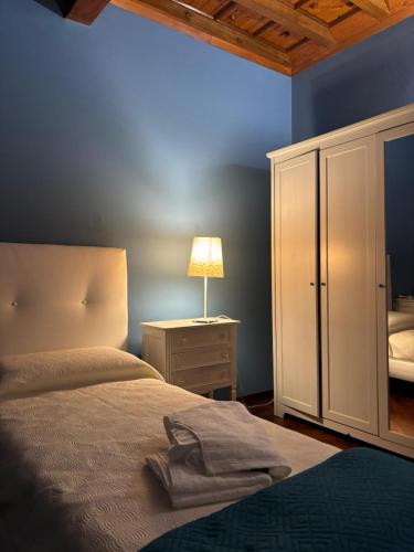 a bedroom with a bed and a lamp on a night stand at Borgo dei Duchi in Rivarolo Mantovano