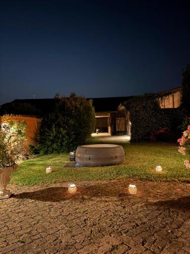 a yard with a tire in the grass at night at Borgo dei Duchi in Rivarolo Mantovano