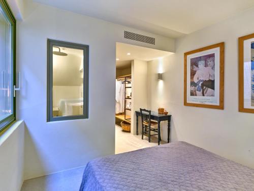 a bedroom with a bed and a mirror at Pezoules House II in Lefkes