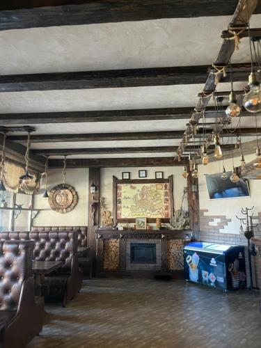 a room with chairs and a fireplace in a building at GT Hotel in Chernivtsi