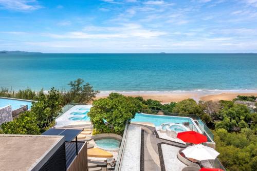 an aerial view of a pool and the beach at Bayphere Hotel Pattaya JC in Na Jomtien
