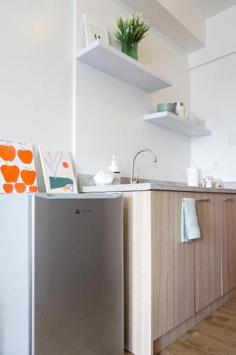a kitchen with a sink and a dishwasher at Cozy Studio Condo Bacolod in Bacolod