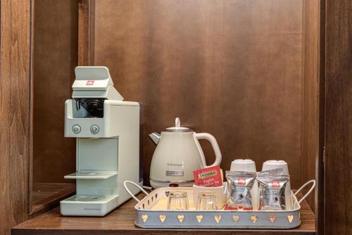 a tray with a coffee maker and a blender on a table at PALAZZO DEL CAPITANO Wellness & Relais - Luxury Borgo Capitano Collection in San Quirico dʼOrcia