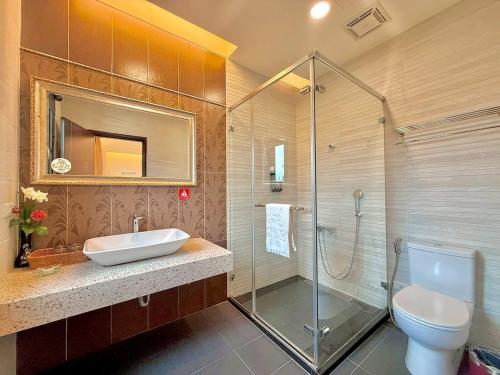 a bathroom with a shower and a sink and a toilet at Kurumba JiJi B&B in Jiji