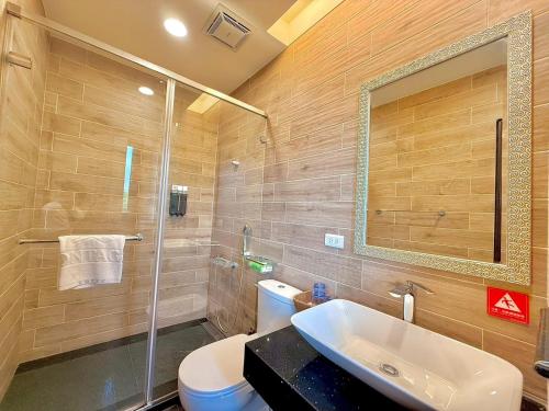 a bathroom with a sink and a toilet and a mirror at Kurumba JiJi B&B in Jiji