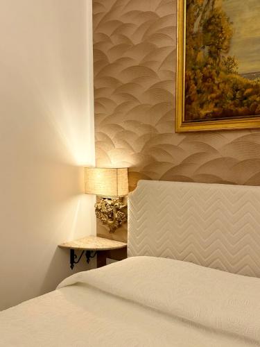 a bedroom with a bed and a picture on the wall at Villa Romilda in Ascea