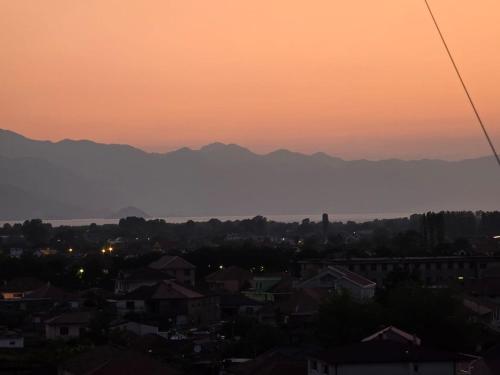 a sunset over a city with mountains in the background at Feel like home 1 in Shkodër
