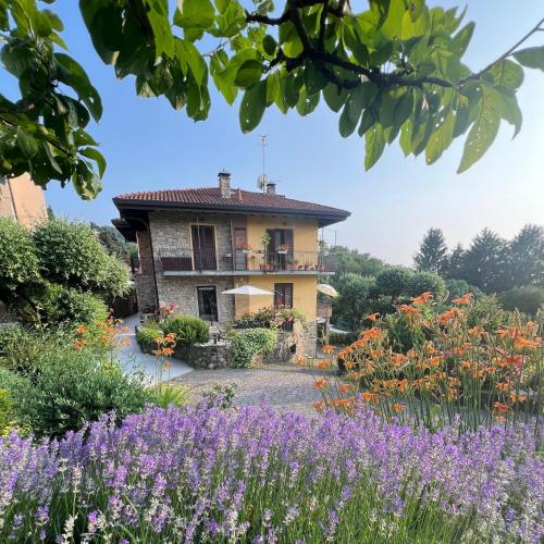 a house with a garden with purple flowers at Al Vecchio Lavatoio - Relax in collina in Colle Brianza