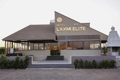 a large building with a sign that reads laxmi elite at Hotel Laxmi Elite Karad in Karad