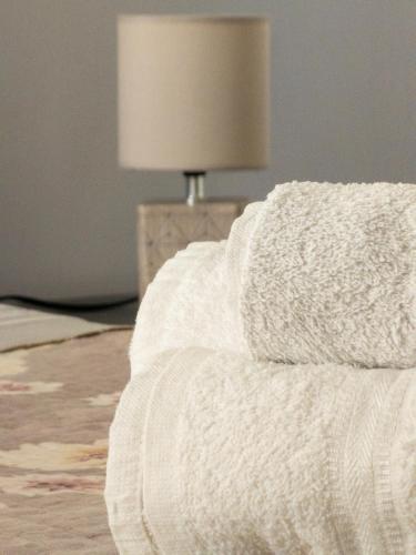 a white couch in a living room with a lamp at B&B Roseal in Brusciano