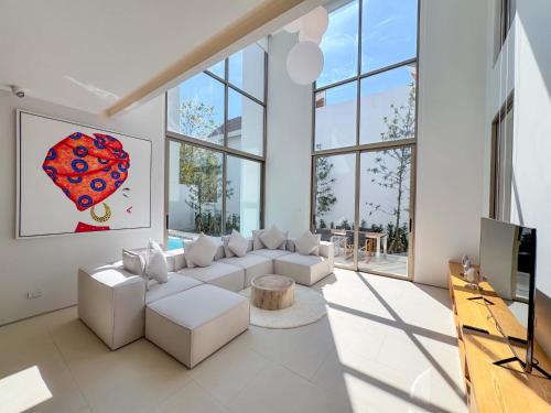 a living room with white furniture and large windows at Modern 3BR Pool Villa near Laguna- Lux Pride 4 by Warm Plus in Ban Pak Lak