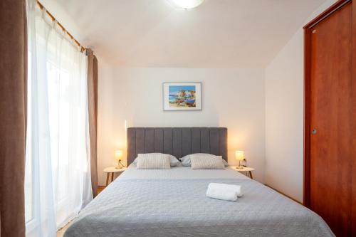 a bedroom with a bed with two lamps on two tables at Apartments Luce in Rovinj