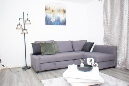 a living room with a couch and a table at Luxe stylish stay in central Manchester in Manchester