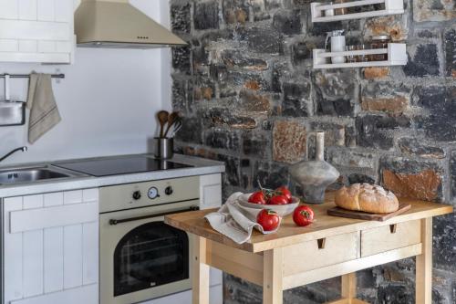 a kitchen with a table with fruits and vegetables on it at Palazzo Greco Villas in Agia Galini