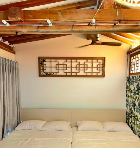 a couch in a room with a window at 'Hanok Hanok' Boutique stay Hotel Seoul - 2min from Gyeongbokgung Palace station in Seoul
