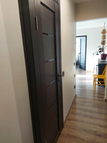 a door leading into a room with a hallway at Elen White Apartment in Rēzekne