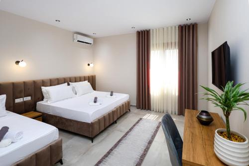 a hotel room with two beds and a table at Vila Erti Berat in Berat
