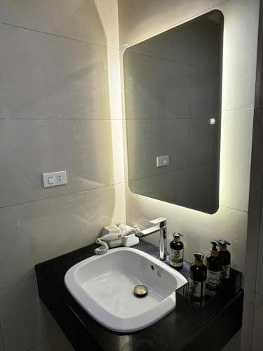 a bathroom with a white sink and a mirror at April twelve in Hanoi