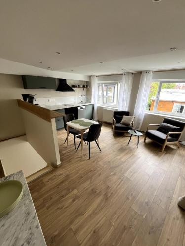 a large living room with a table and chairs at Joli appartement au centre de Nieppe in Nieppe