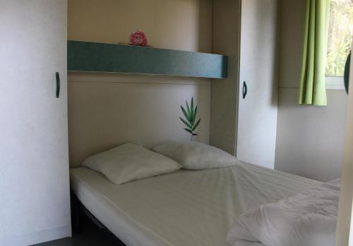 a bedroom with a bunk bed with a plant on it at Camping Le Balcon de Chartreuse in Miribel-les-Échelles