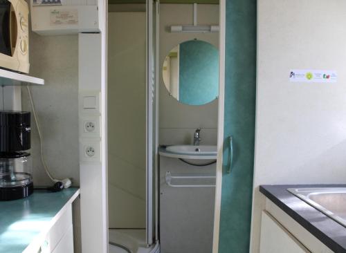 a small bathroom with a sink and a toilet at Camping Le Balcon de Chartreuse in Miribel-les-Échelles