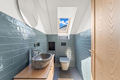 a bathroom with a sink and a toilet at Dunique in Palanga