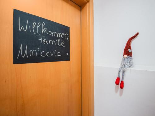 a sign on a wall with a monkey hanging on it at Modern Apartment in Kitzbuhel near Ski Area in Kitzbühel